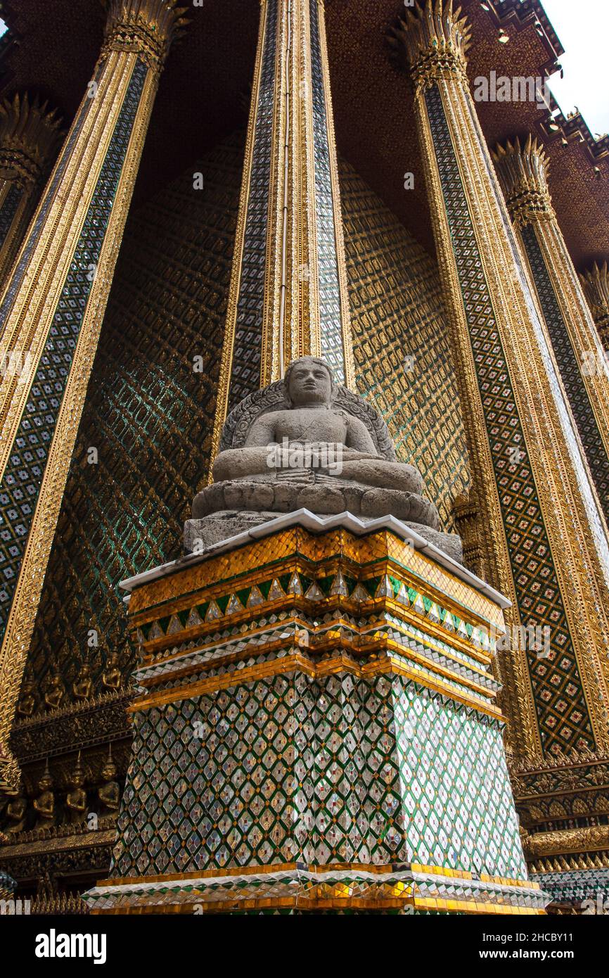 Tall gold decorated tower with Buddha statue at Grand Palace Bangkok, Thailand Stock Photo