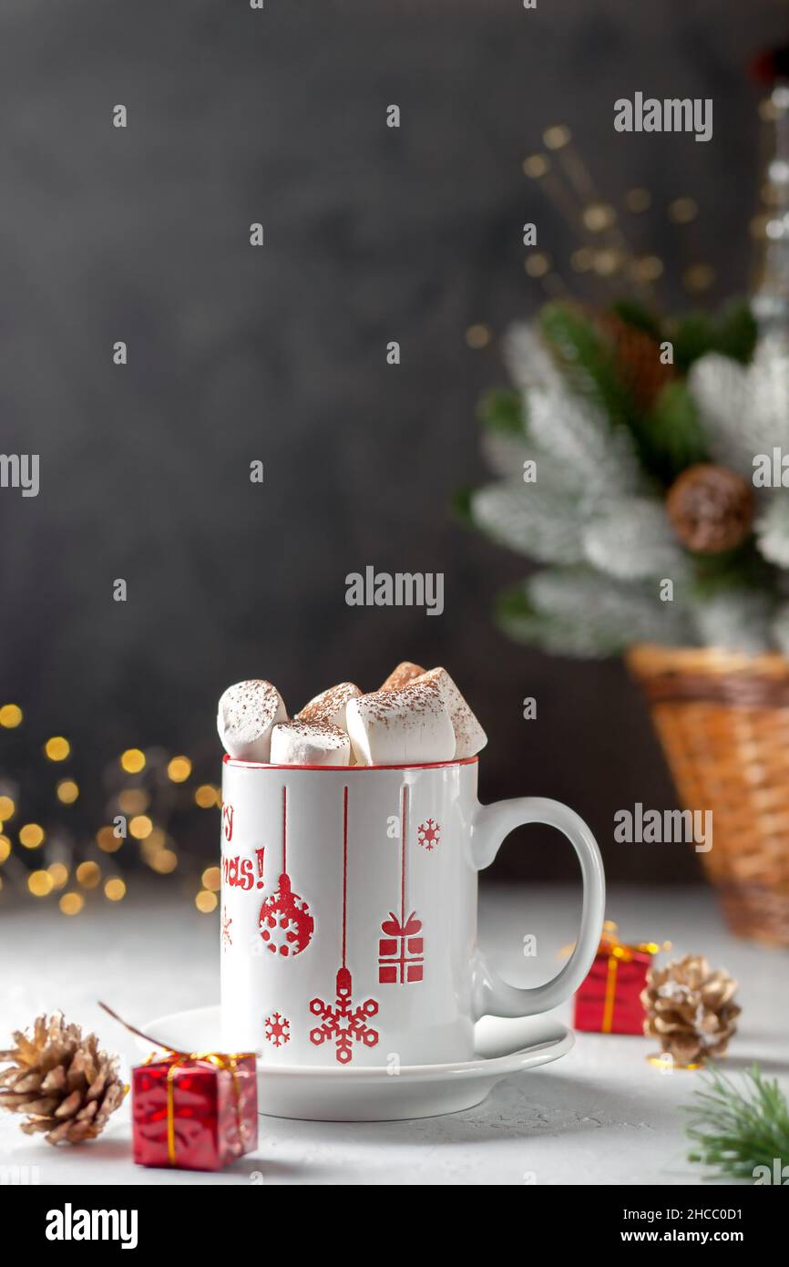 Marshmallows and a cup of latte on the background of Christmas tree Stock Photo