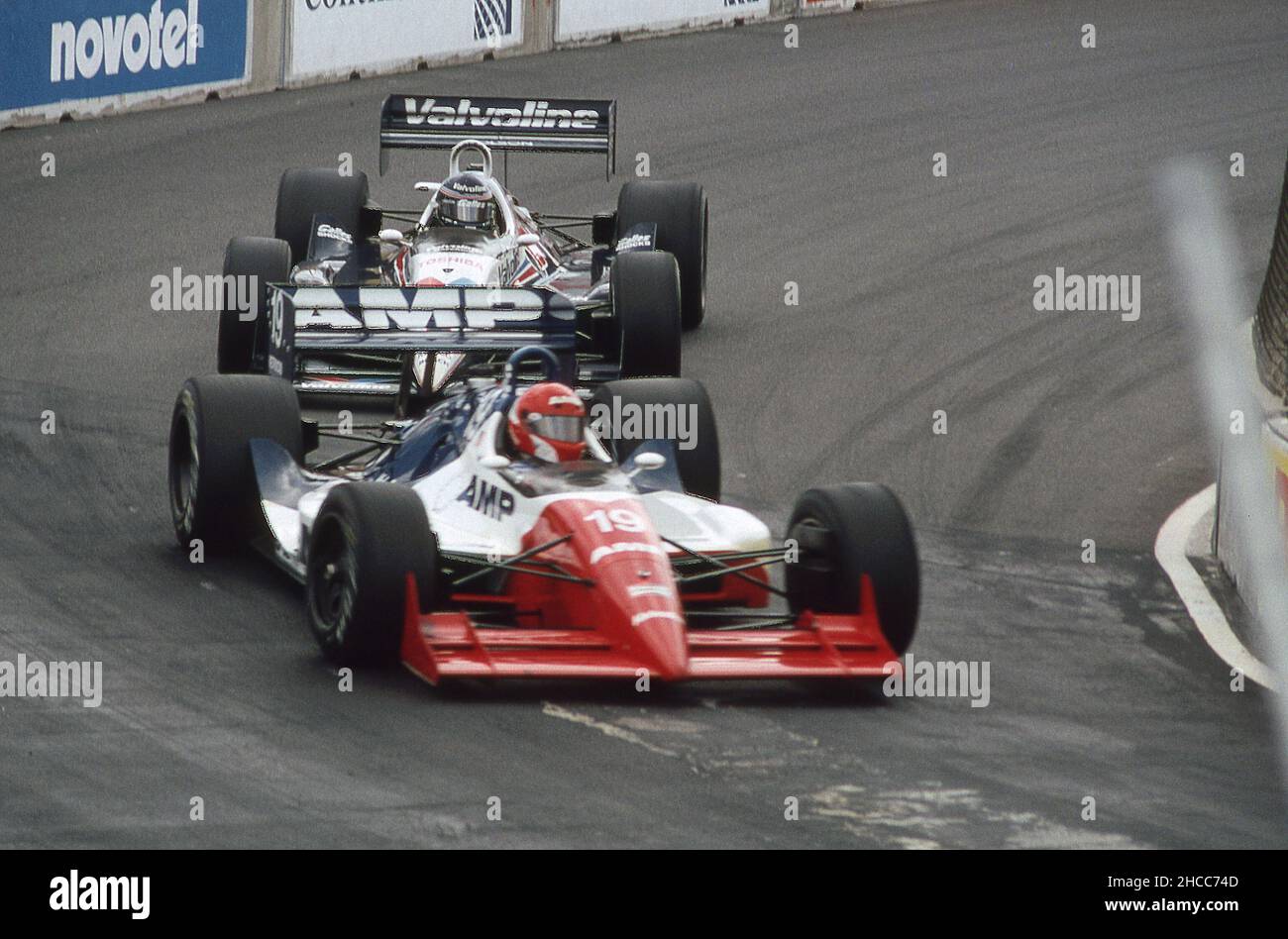 Indy cars racing at various tracks during the 1980's These open wheel cars can exceed 220 miles per hour. Pit crews service cars in seconds. Stock Photo