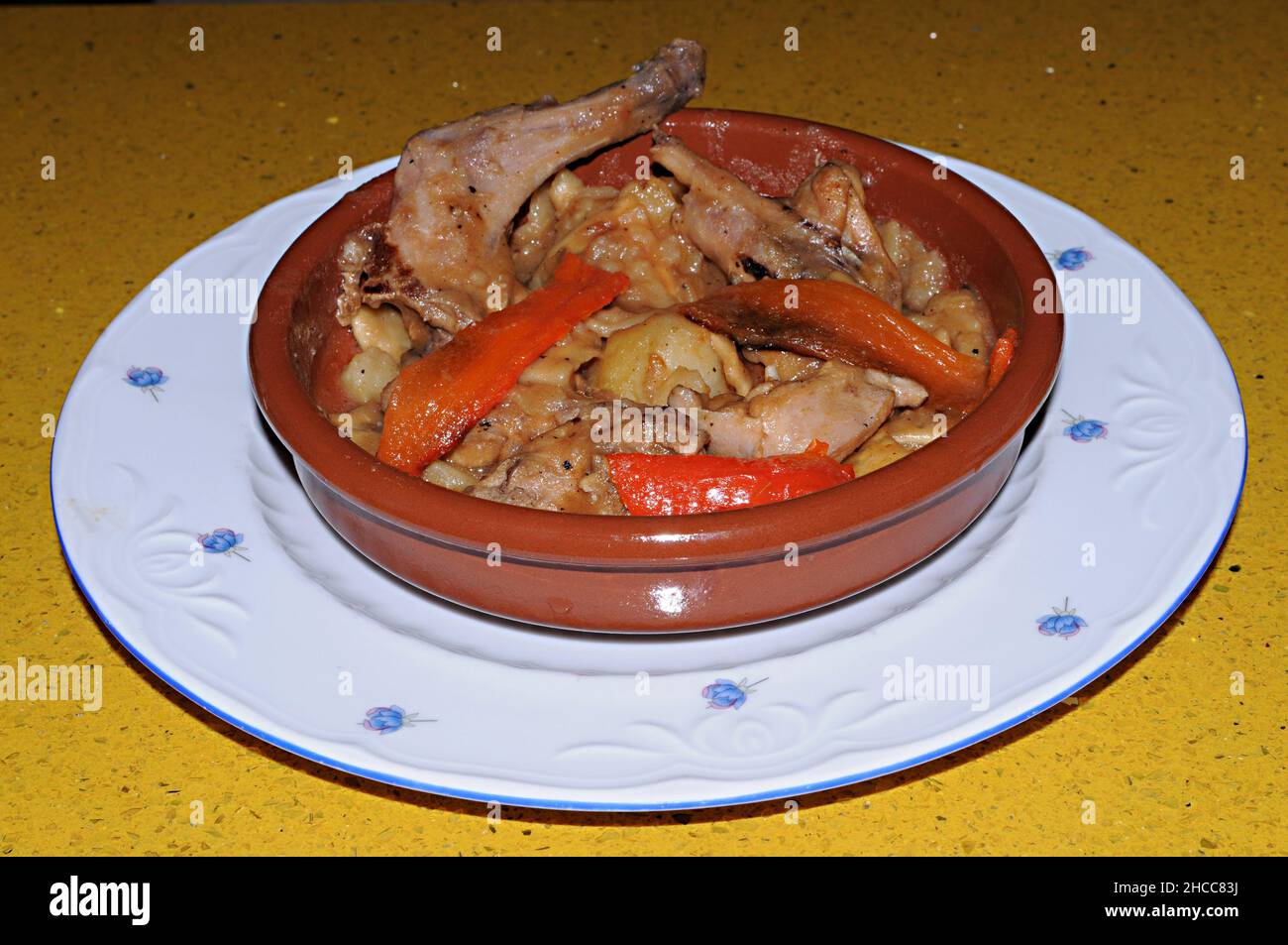 Baked rabbit in tomato sauce with rosemary and basil. Italian Cuisine. Stock Photo