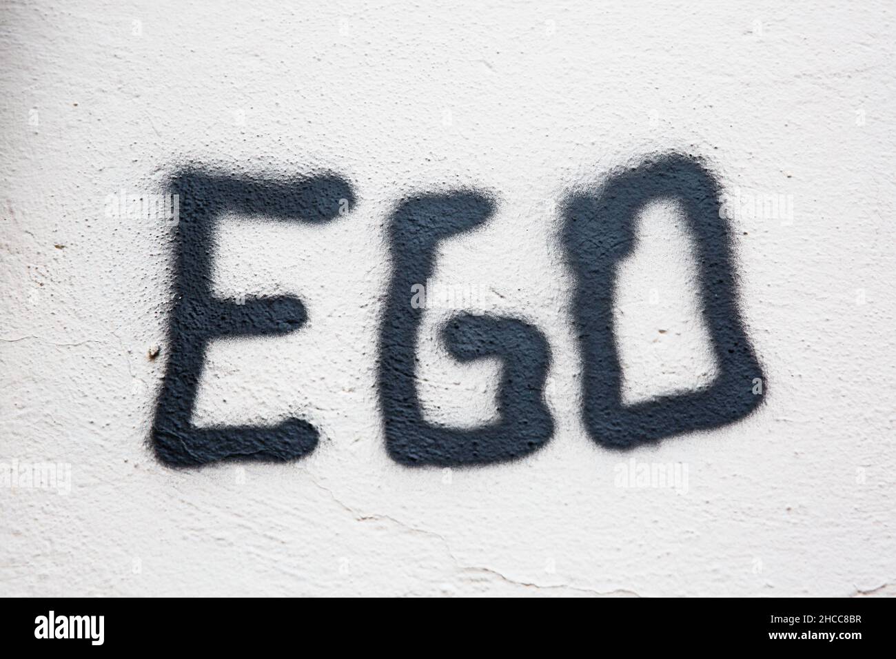 Ego, Characters On A Wall, Close Up Full Frame. Egoism, Selfish. Stock Photo