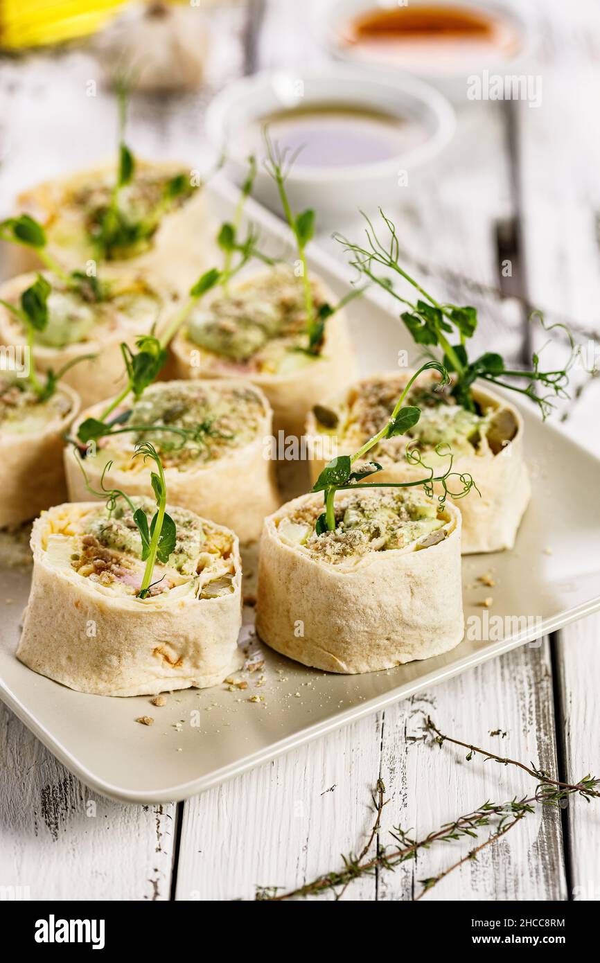 Tortilla deli wrap rolls with chicken ham and vegetable. Wheat sandwich