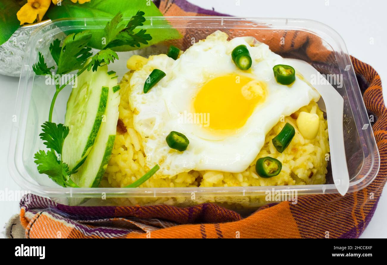 Mixed potato and rice salad with half fried chicken egg. Favorite street food in Asia, Myanmar. Stock Photo