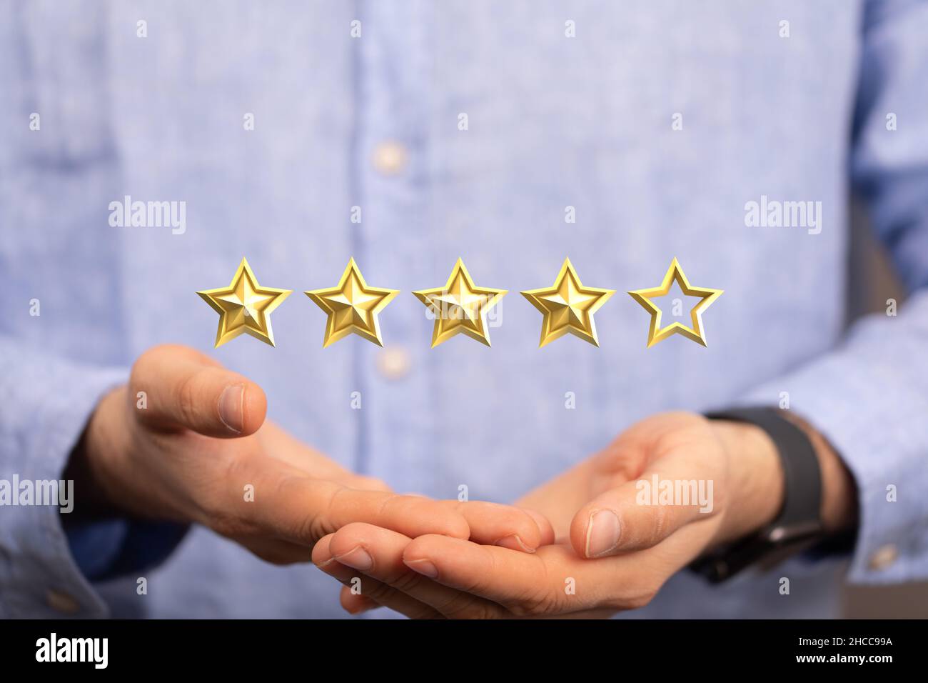 Closeup of the man's hands holding five stars ranking system Stock ...