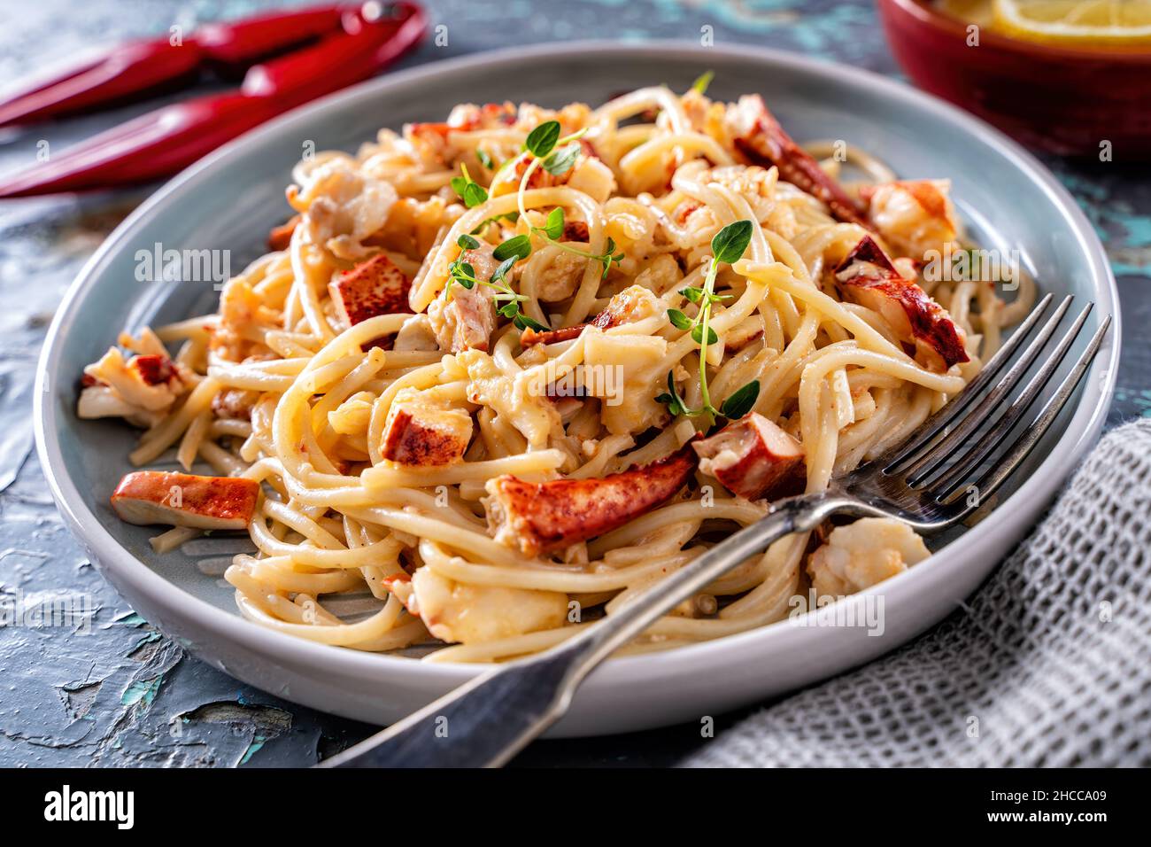 Delicious creamy Maine lobster pasta with lemon and thyme. Stock Photo