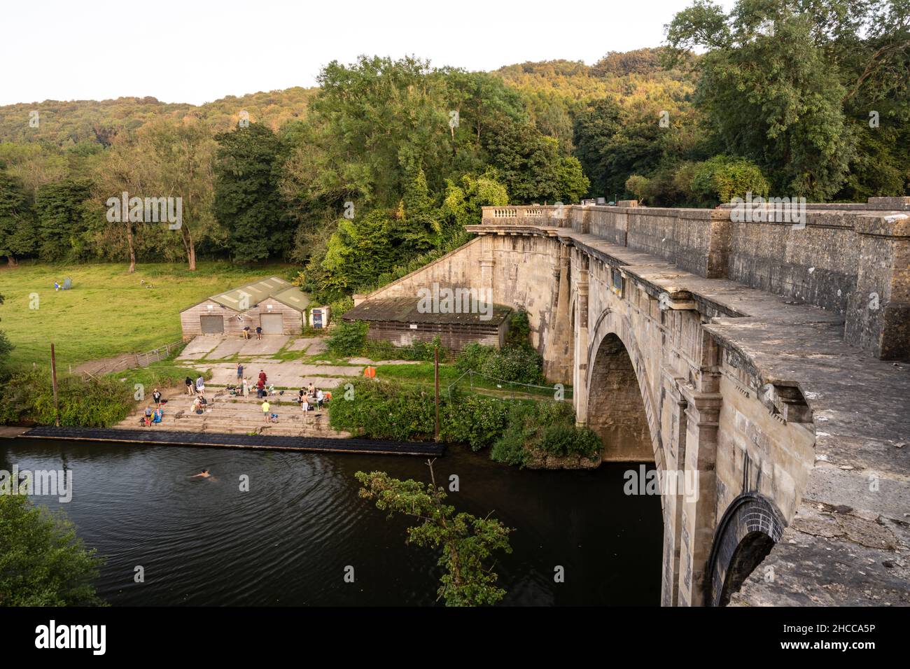 People gather for wild swimming and rowing in the River Avon beneath Dundas Aquaduct near Bath. Stock Photo