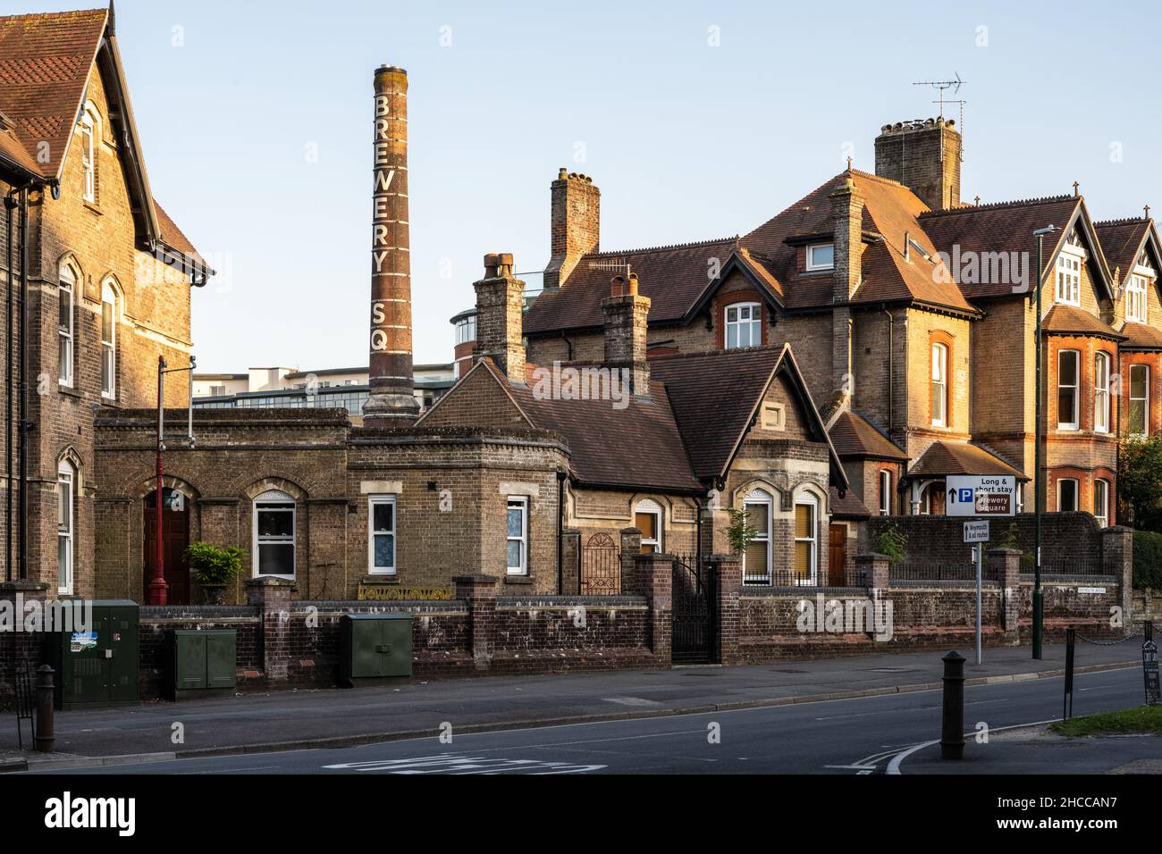 The old industrial chimney of Brewery Square rises above houses in Dorchester, Dorset. Stock Photo