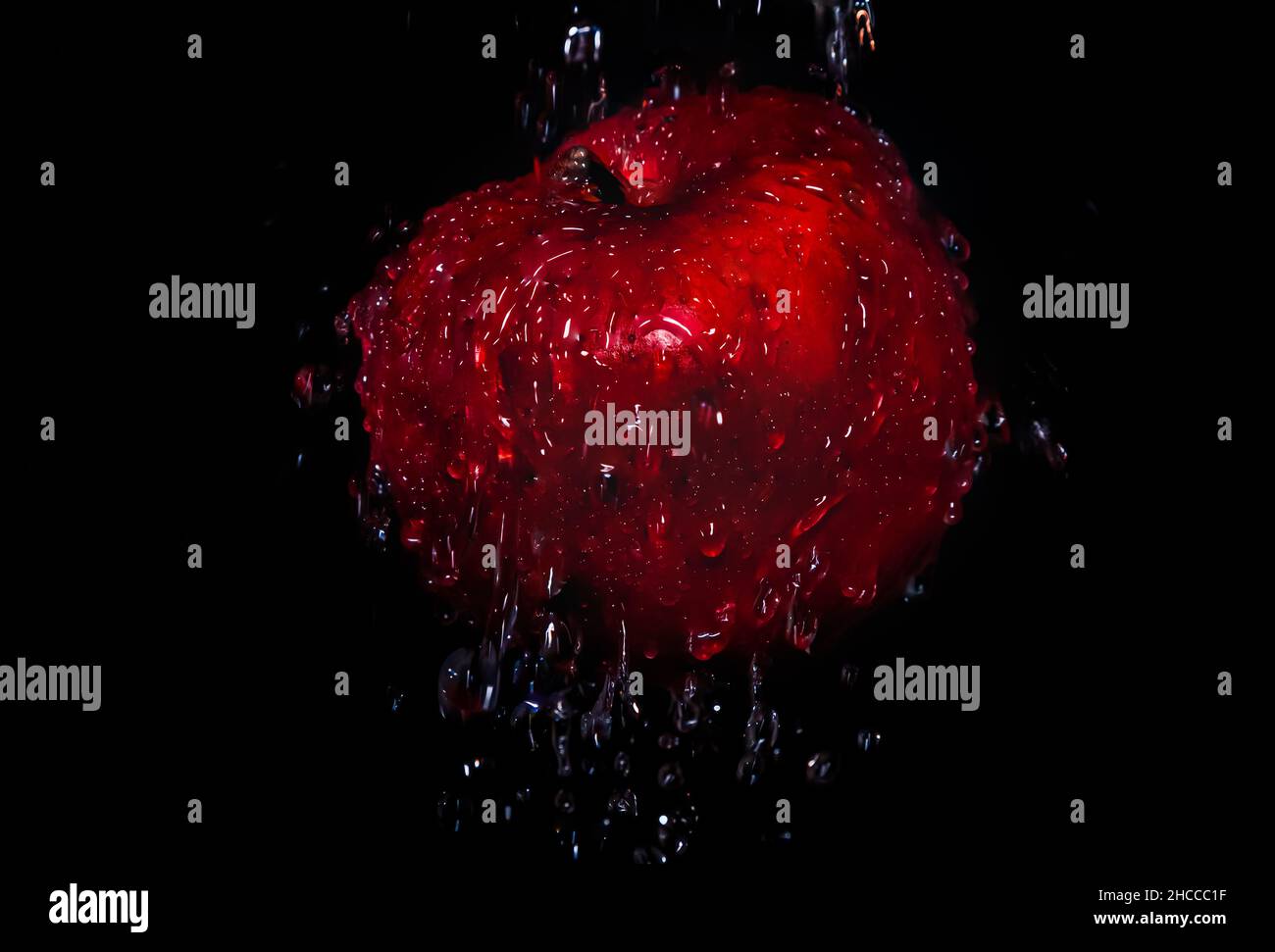 Red apple with water drops on black background Stock Photo