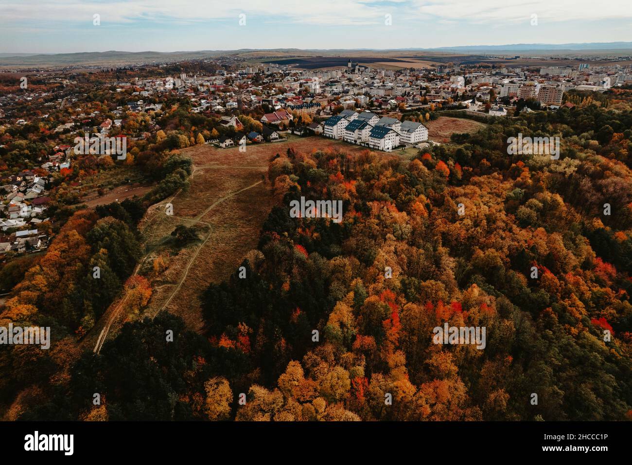 An aerial view of an autumnal forest near a village Stock Photo - Alamy