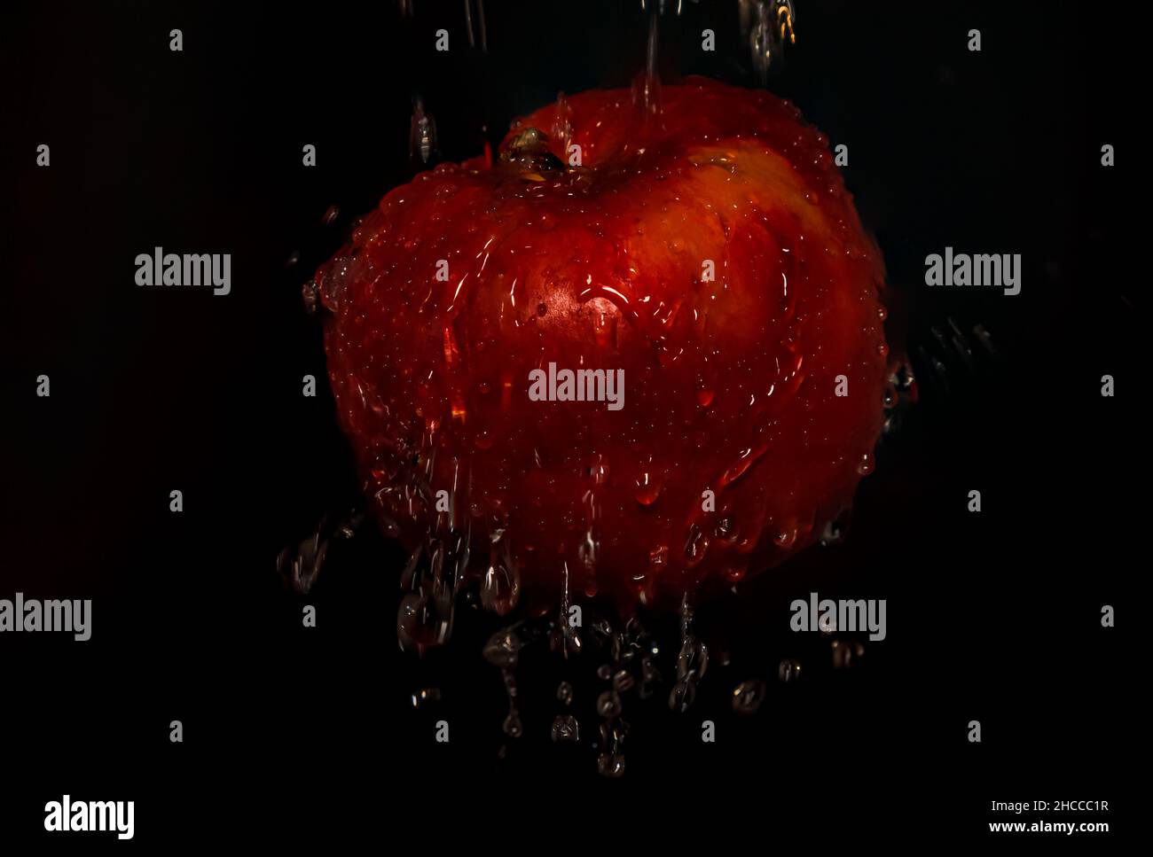 Red apple with water drops on black background Stock Photo