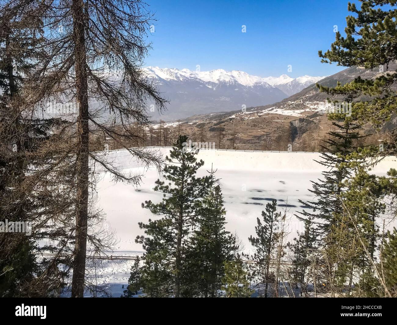 Mountain landscape under snow in winter and frozen lake Stock Photo