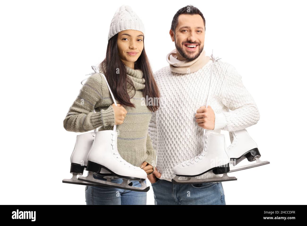 Young man and woman carrying ice skates on shoulder isolated on white