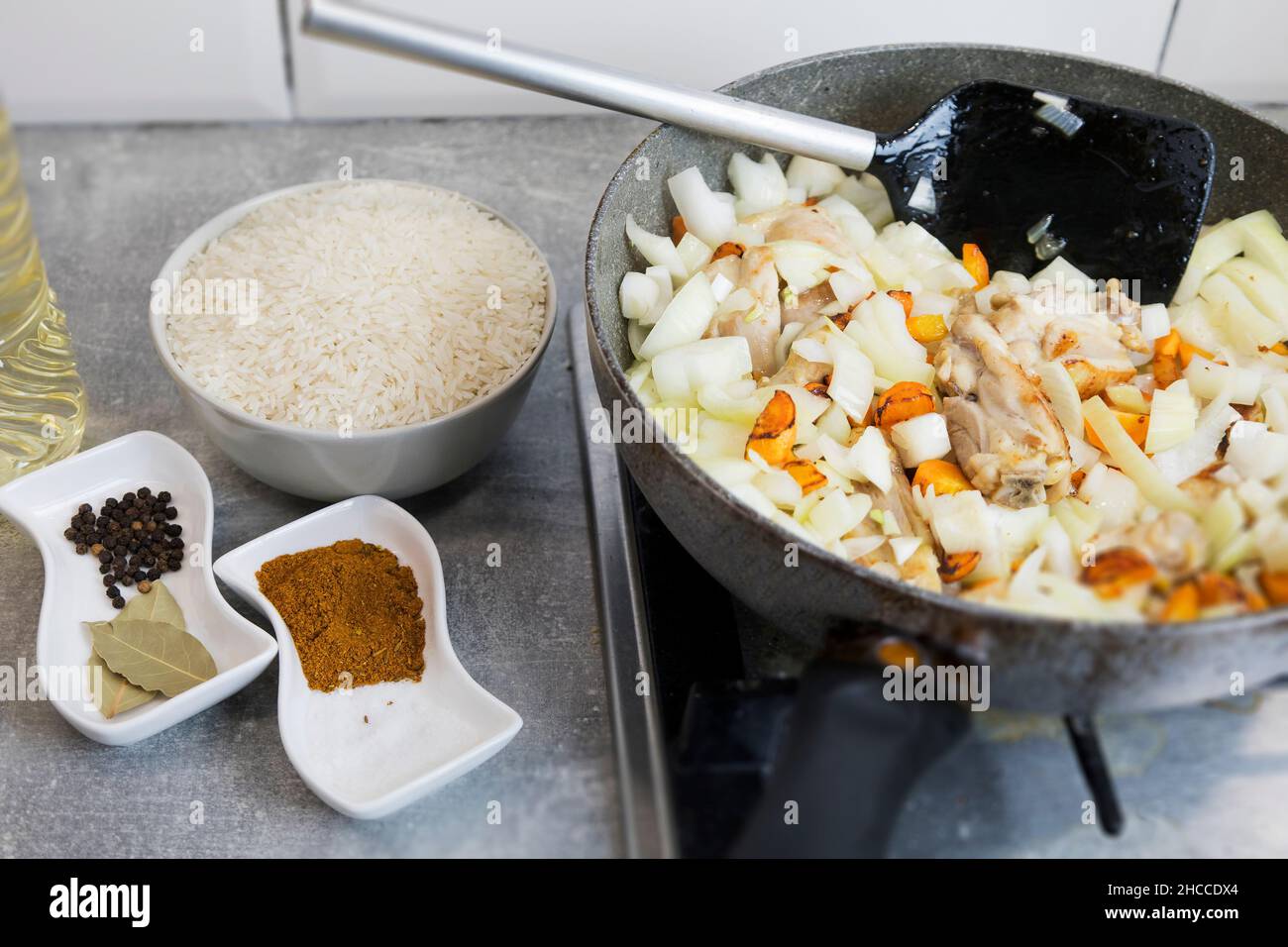 Ingredients for pilaf. Carrots, onion bulbs, rice, sliced meat, salt