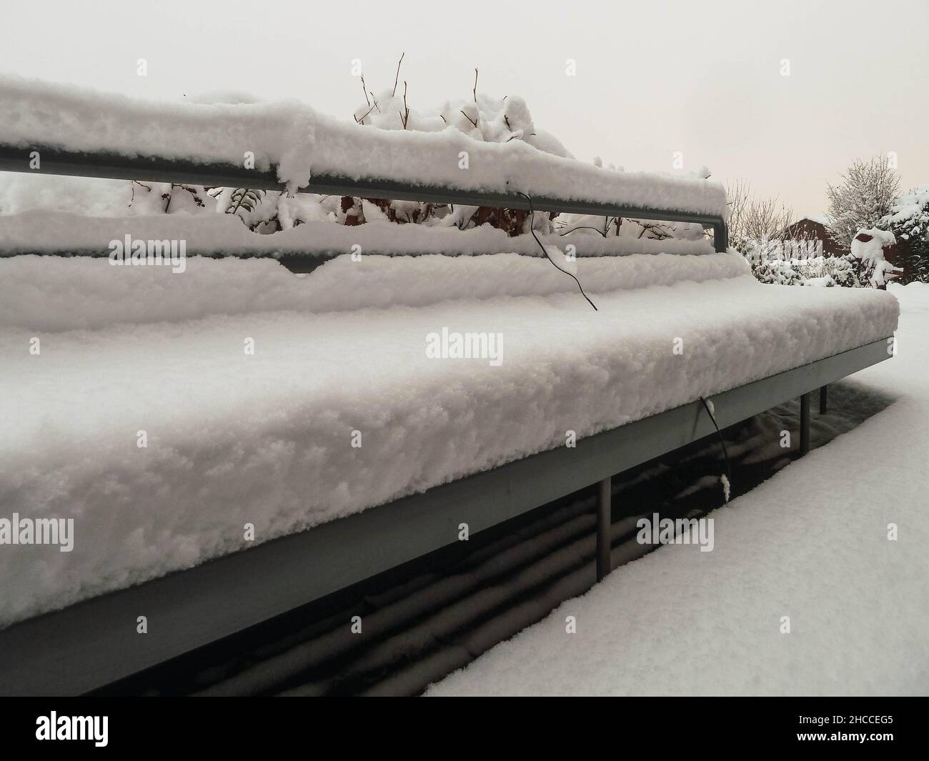 Bench covered in snow in a park Stock Photo - Alamy
