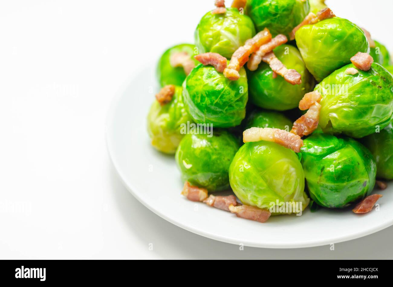 Tasty brussels sprouts with smoked bacon lardons and salted butter
