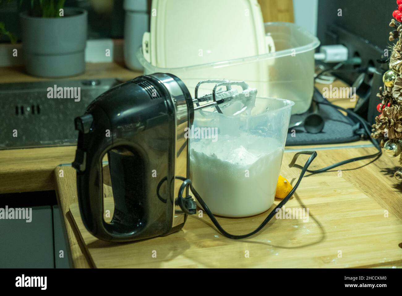 Whipped cream and black mixer on kitchen Stock Photo
