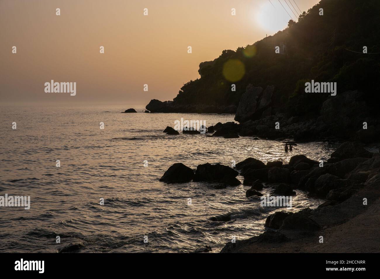 Beautiful scenic view over fantastic sunset seascape. Mirtiotissa beach, Corfu island, Greece. Stock Photo