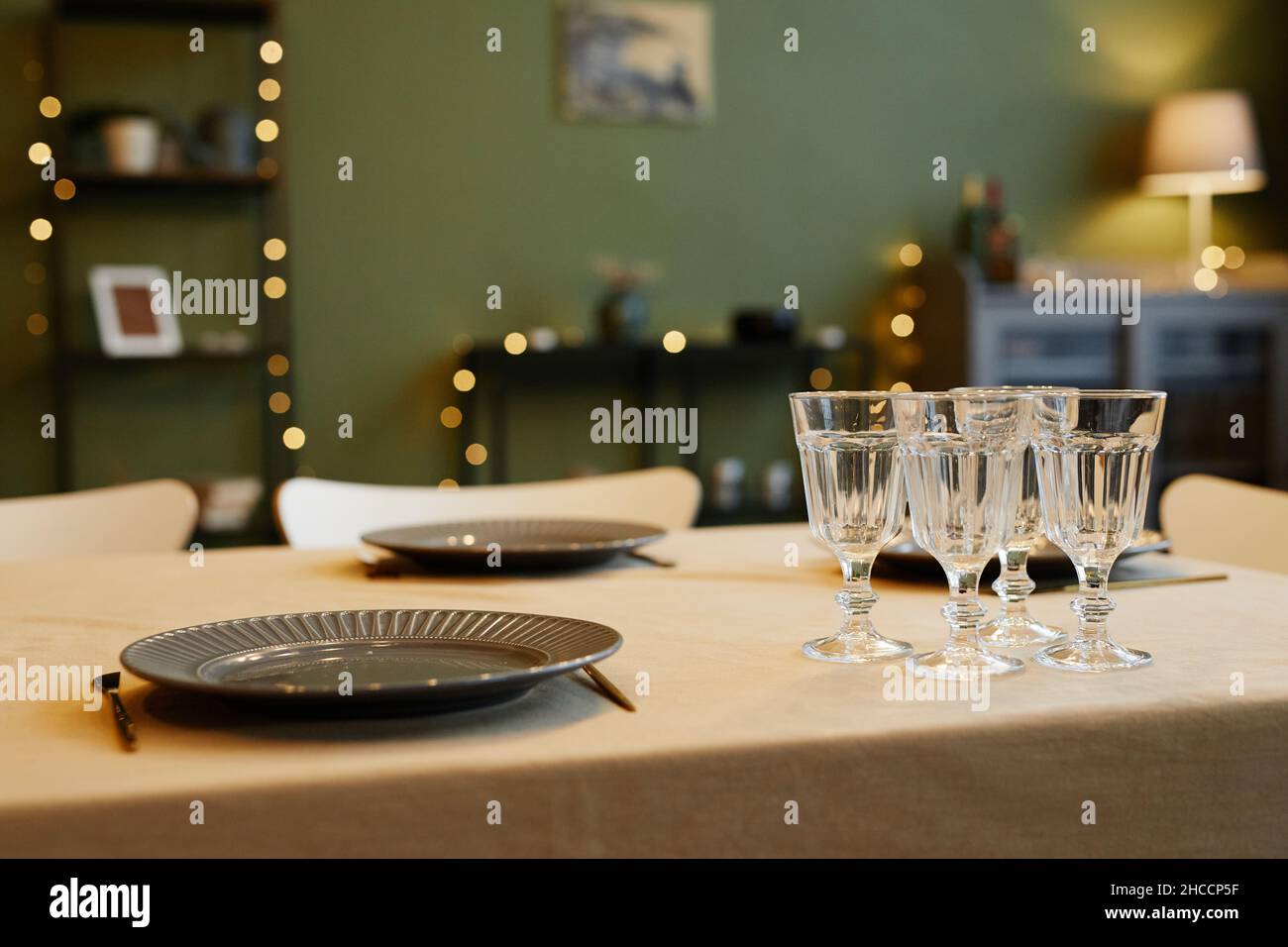 Close up of dining table with beautiful dishes and glasses against