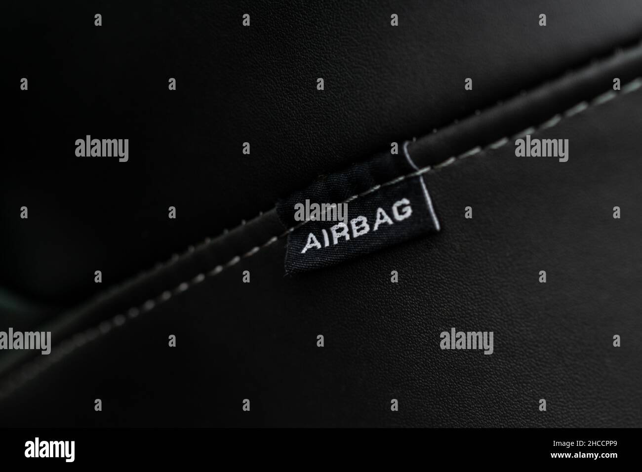 Close up view of airbag label on the side of a car seat. Airbag safety system symbol on the car seat. Modern car interior details. Stock Photo