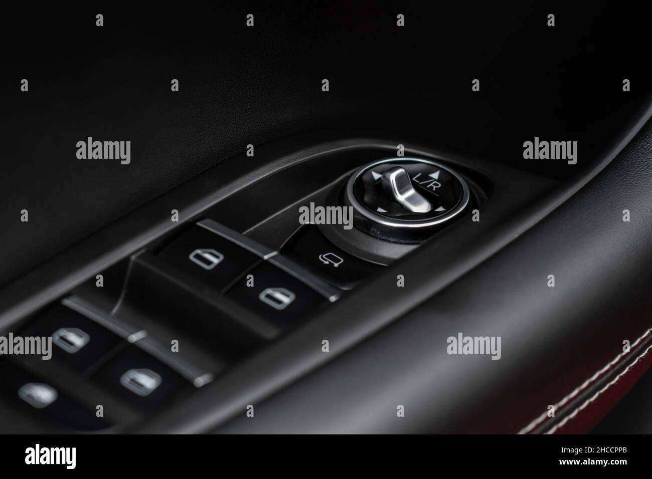 Side mirrors control panel on side door. Car driver adjust side mirror