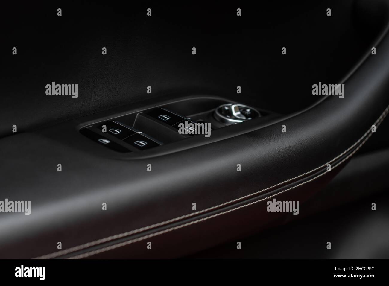 Side mirrors control panel on side door. Car driver adjust side mirror