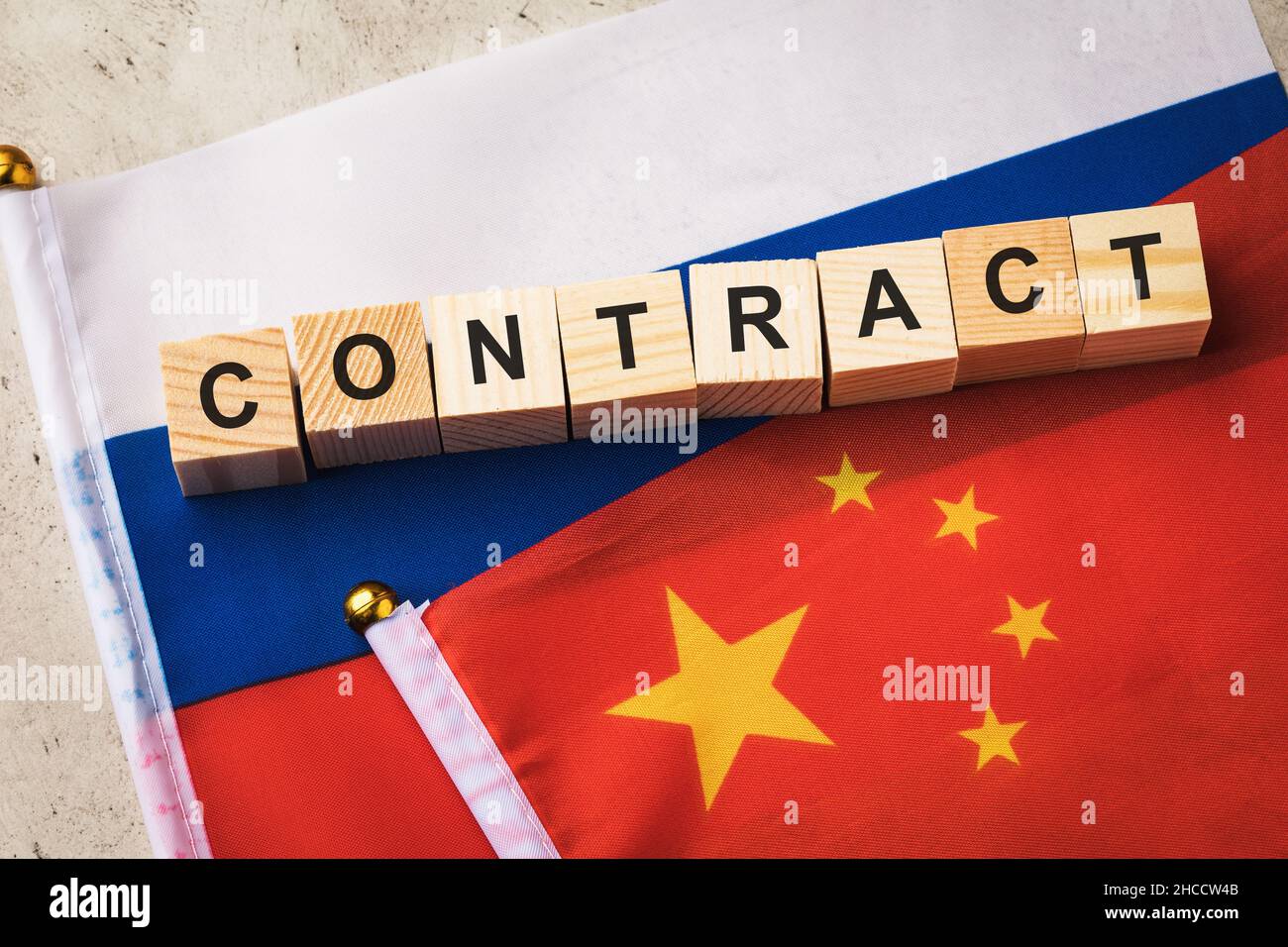 Wooden cubes with text surrounded by flags of Russia and China, a concept on the theme of relations between countries Stock Photo