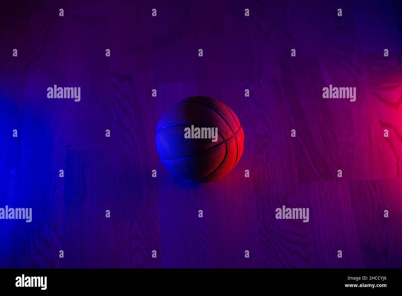 Basketball ball isolated on dark background. Blue neon banner