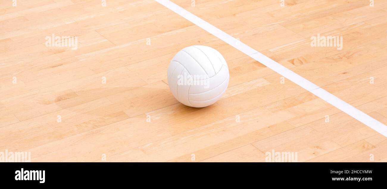 Volleyball ball and white line on wooden court. Horizontal education and sport poster, greeting cards, headers, website Stock Photo