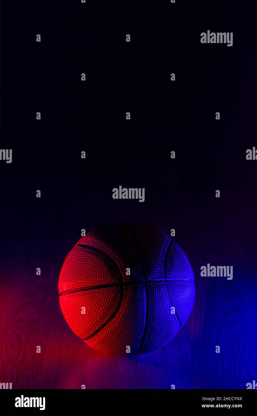 Basketball ball isolated on dark background. Blue neon banner. Vertical