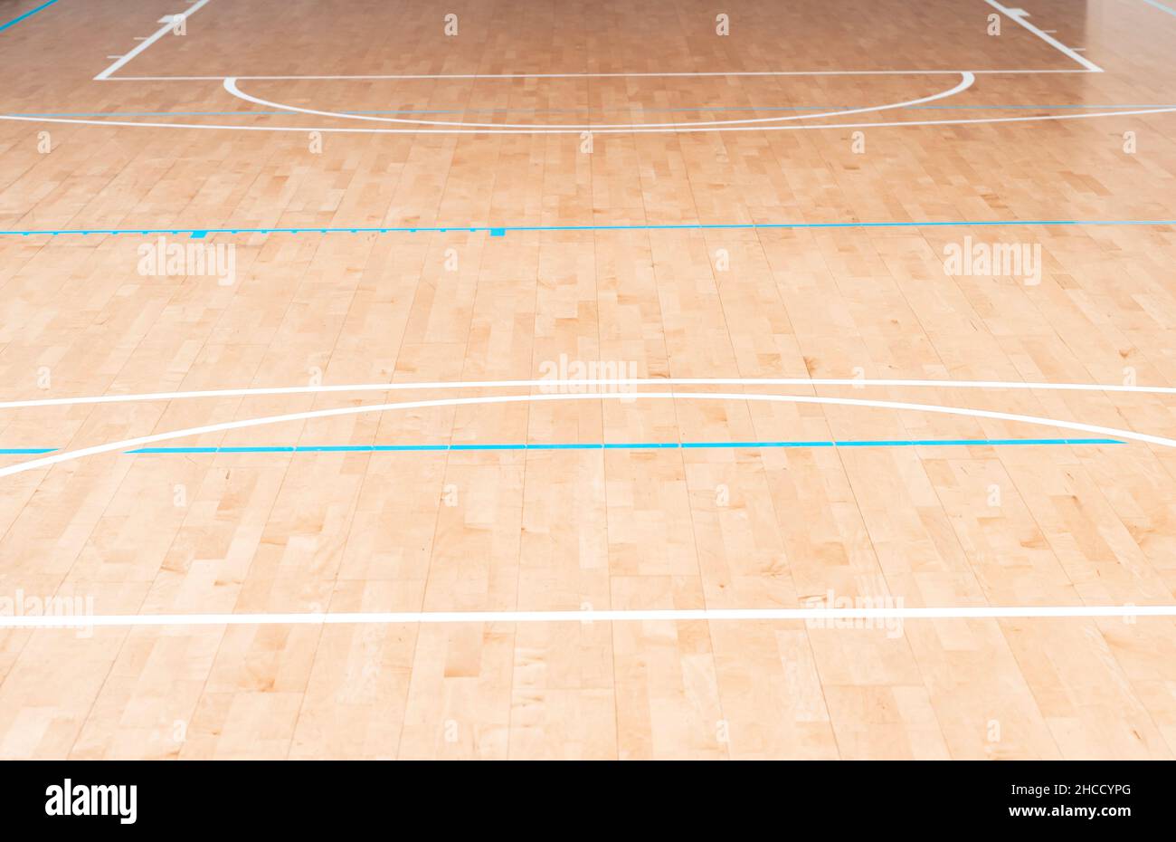 Wooden floor  basketball, badminton, futsal, handball, volleyball, football, soccer court. Wooden floor of sports hall with marking blue and white lin Stock Photo