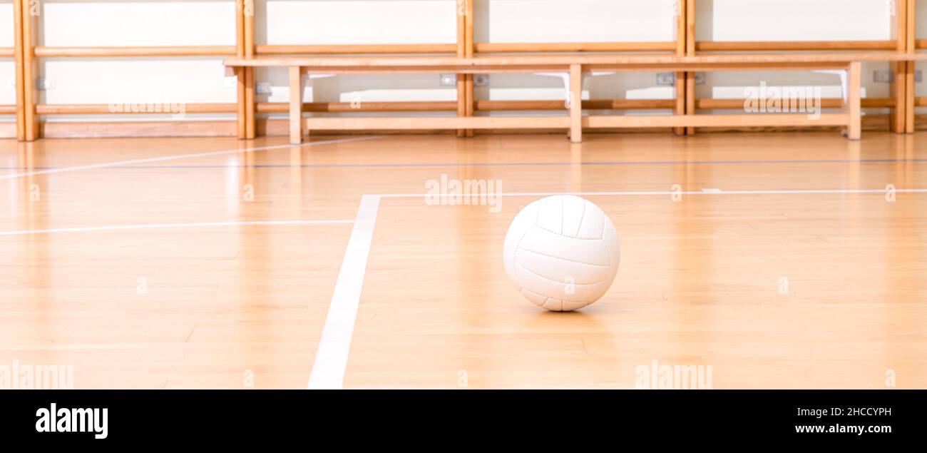 Volleyball ball and white line on wooden court. Horizontal education and sport poster, greeting cards, headers, website Stock Photo