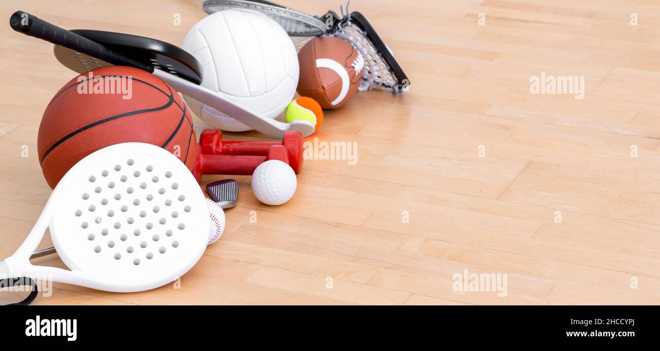 Sports equipment, rackets and balls on hardwood court floor. Horizontal education and sport poster, greeting cards, headers, website Stock Photo