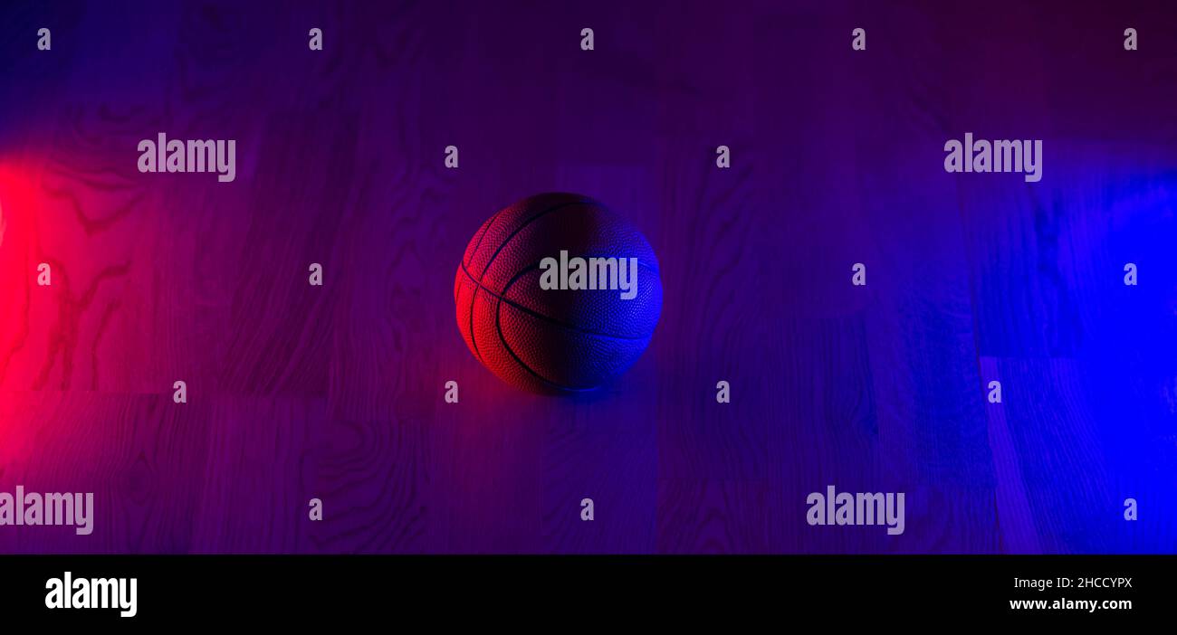 Basketball ball isolated on dark background. Blue neon banner
