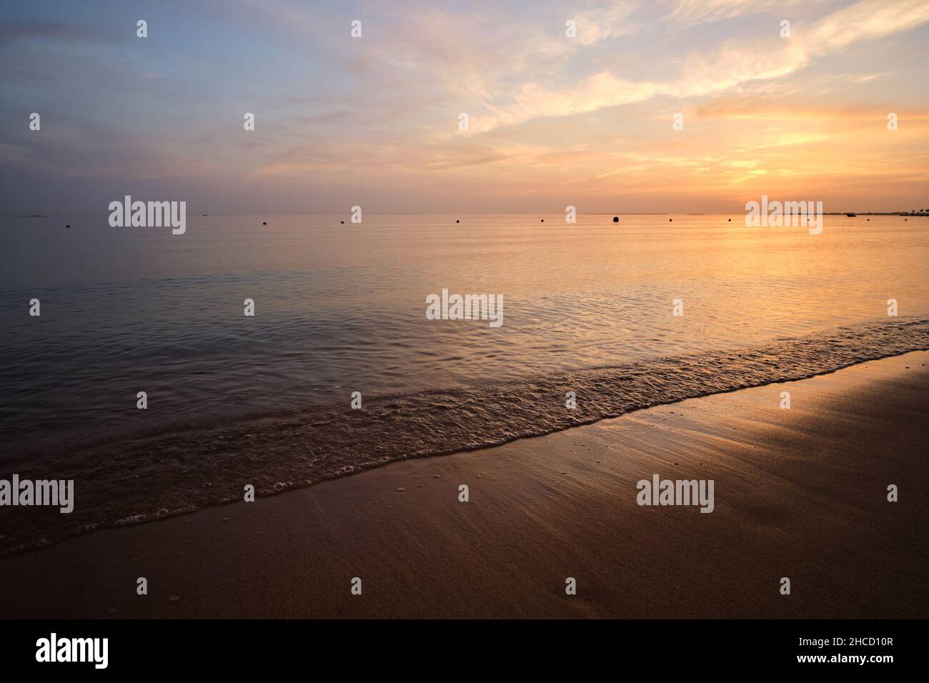 Calm sea shore with crushing waves on sandy beach at sunrise Stock ...