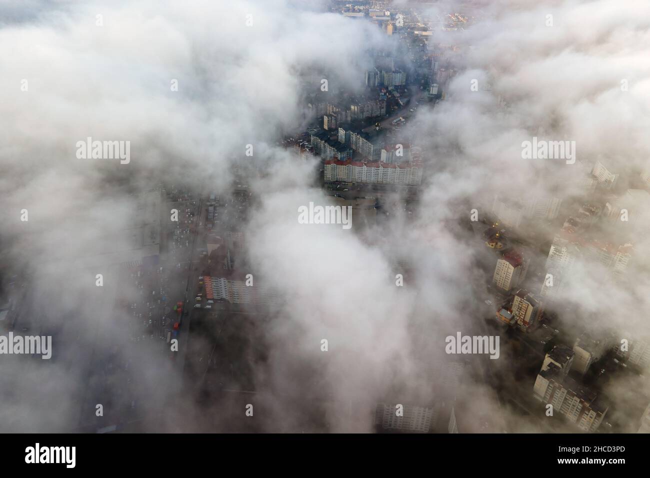 Top aerial view of fluffy white clouds over modern city with high rise ...