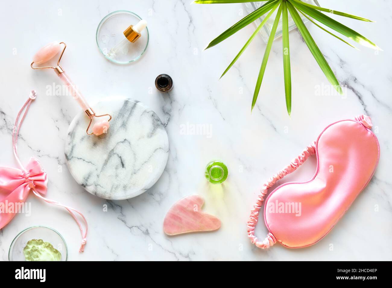 Facial massage. Moisturizer, pink rosa quarz face roller and gua sha