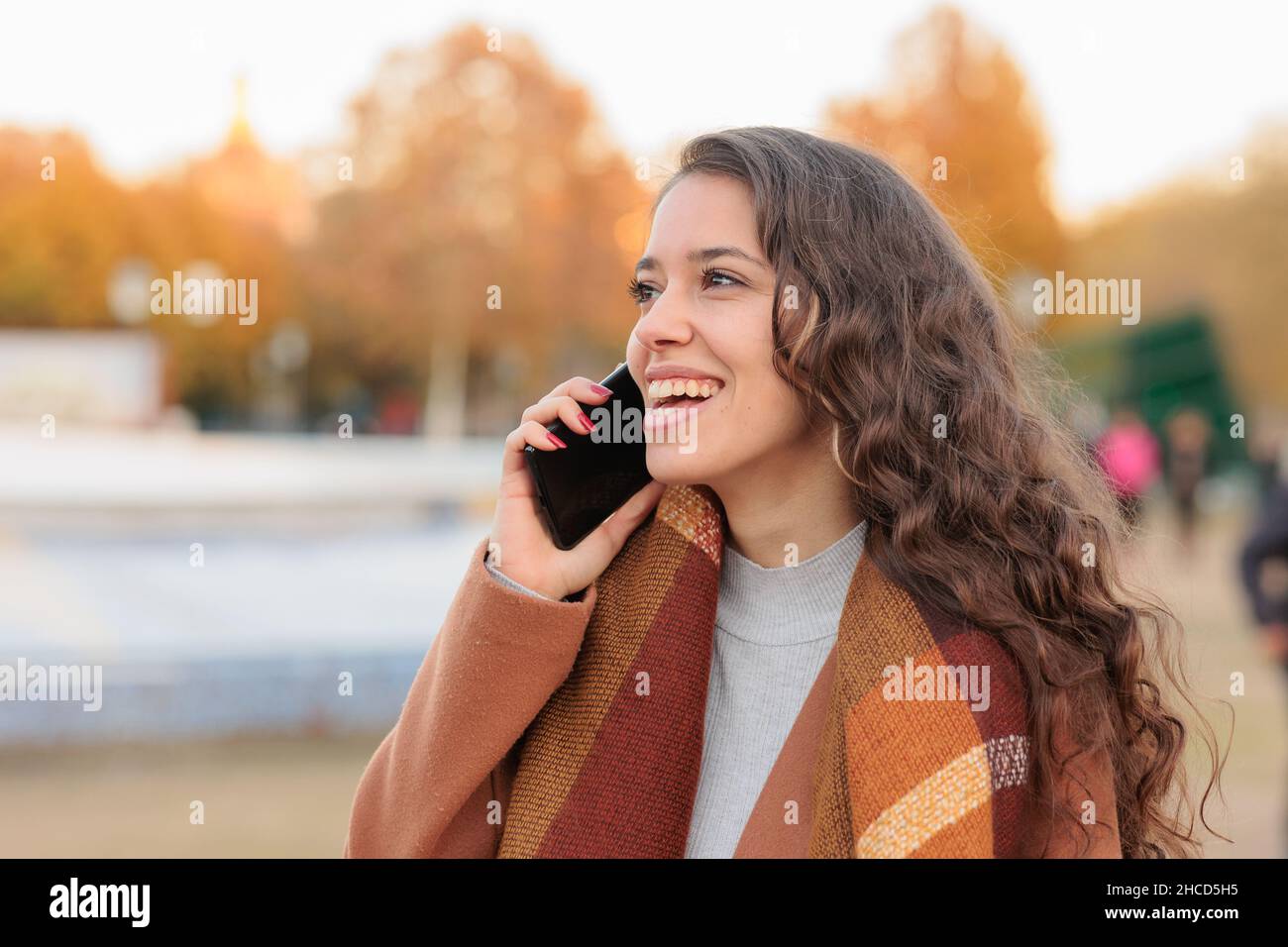 Spanish business woman communicating with smartphone in Castilla la mancha, Toledo. Fall colors Stock Photo