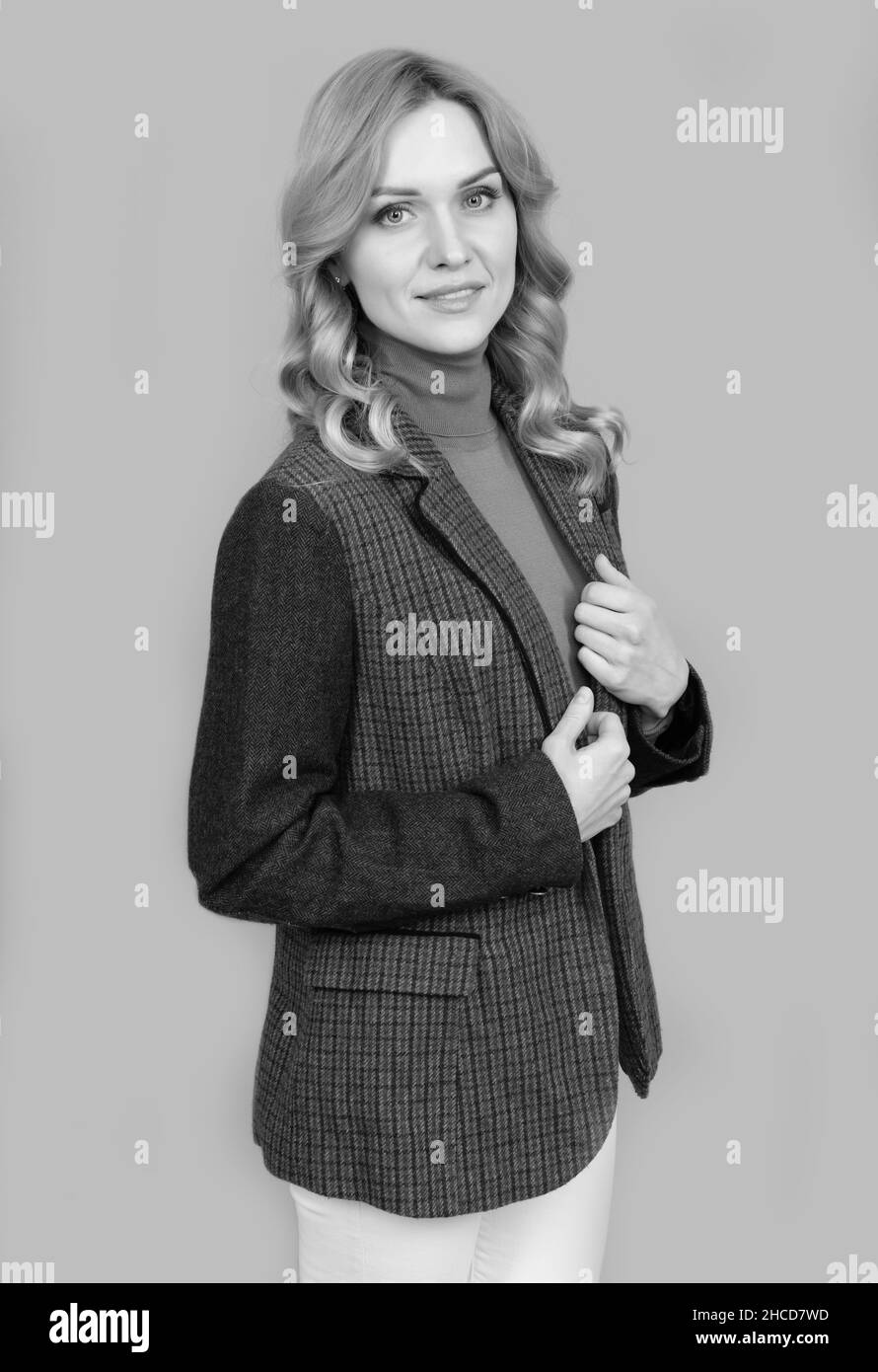 confident blonde woman in checkered english jacket, businesswoman Stock Photo