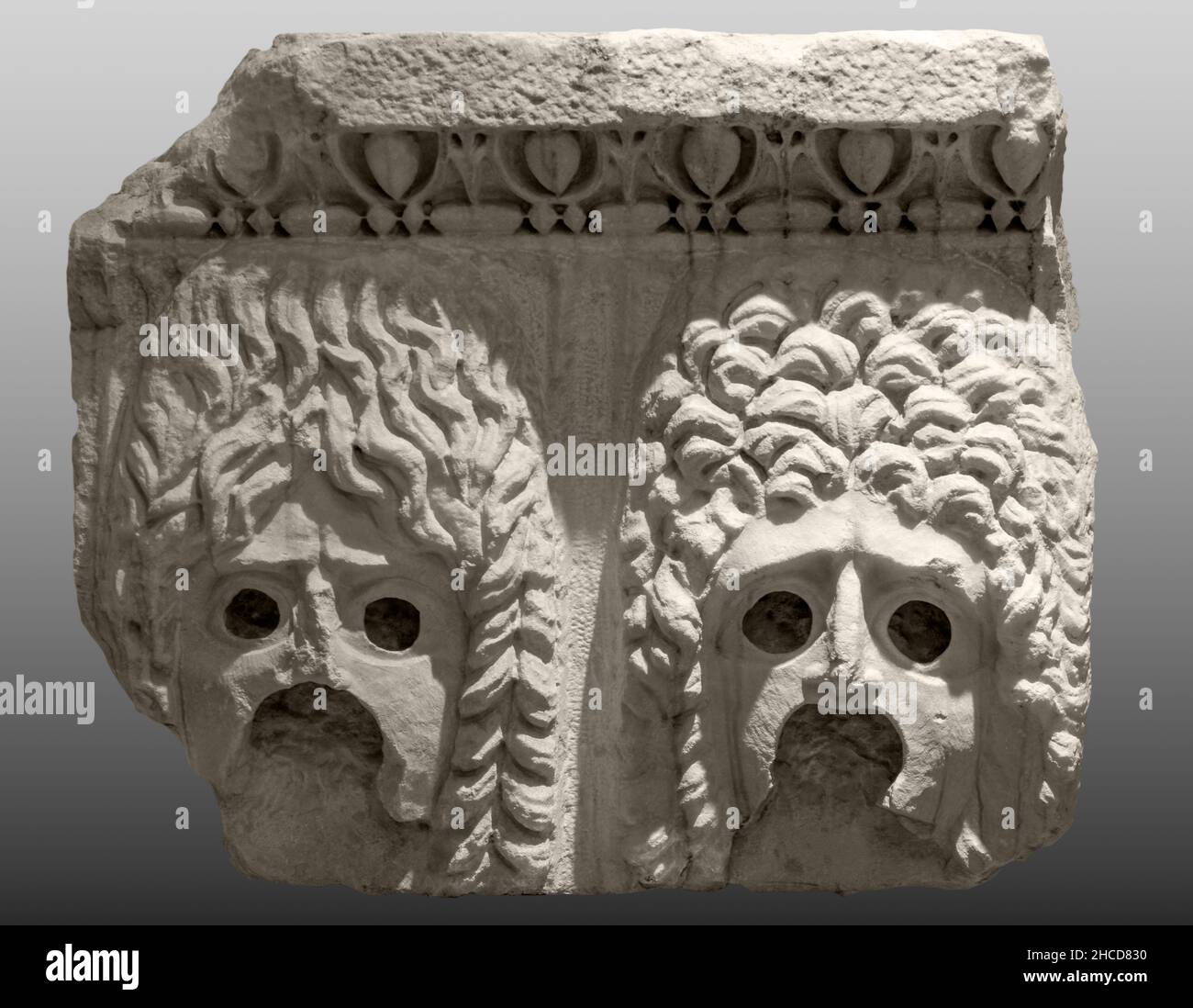 Ancient Greek theatrical masks - marble scenery of the entablature Stock Photo