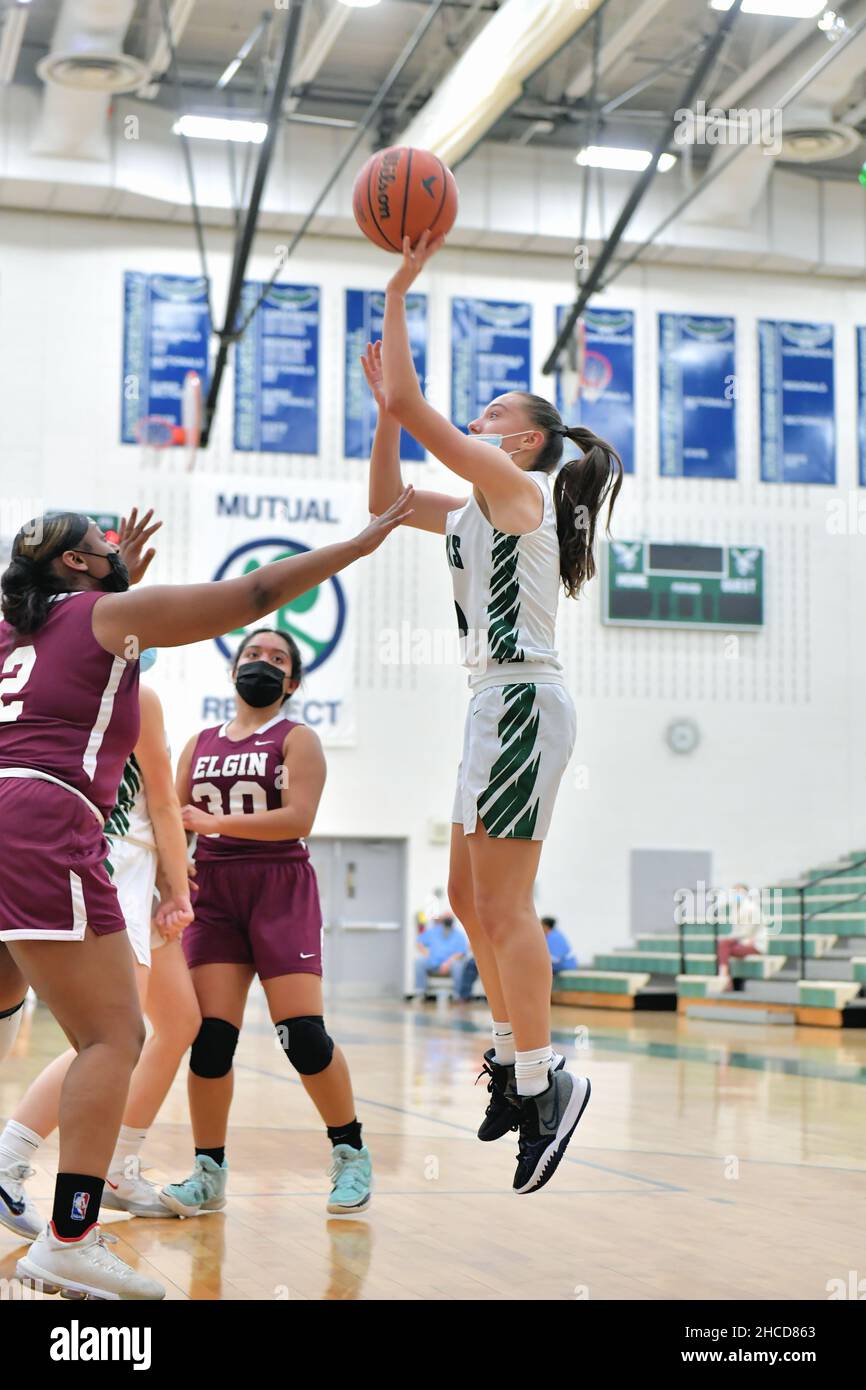 USA. Player taking a jump shot over the defense of the two opponents