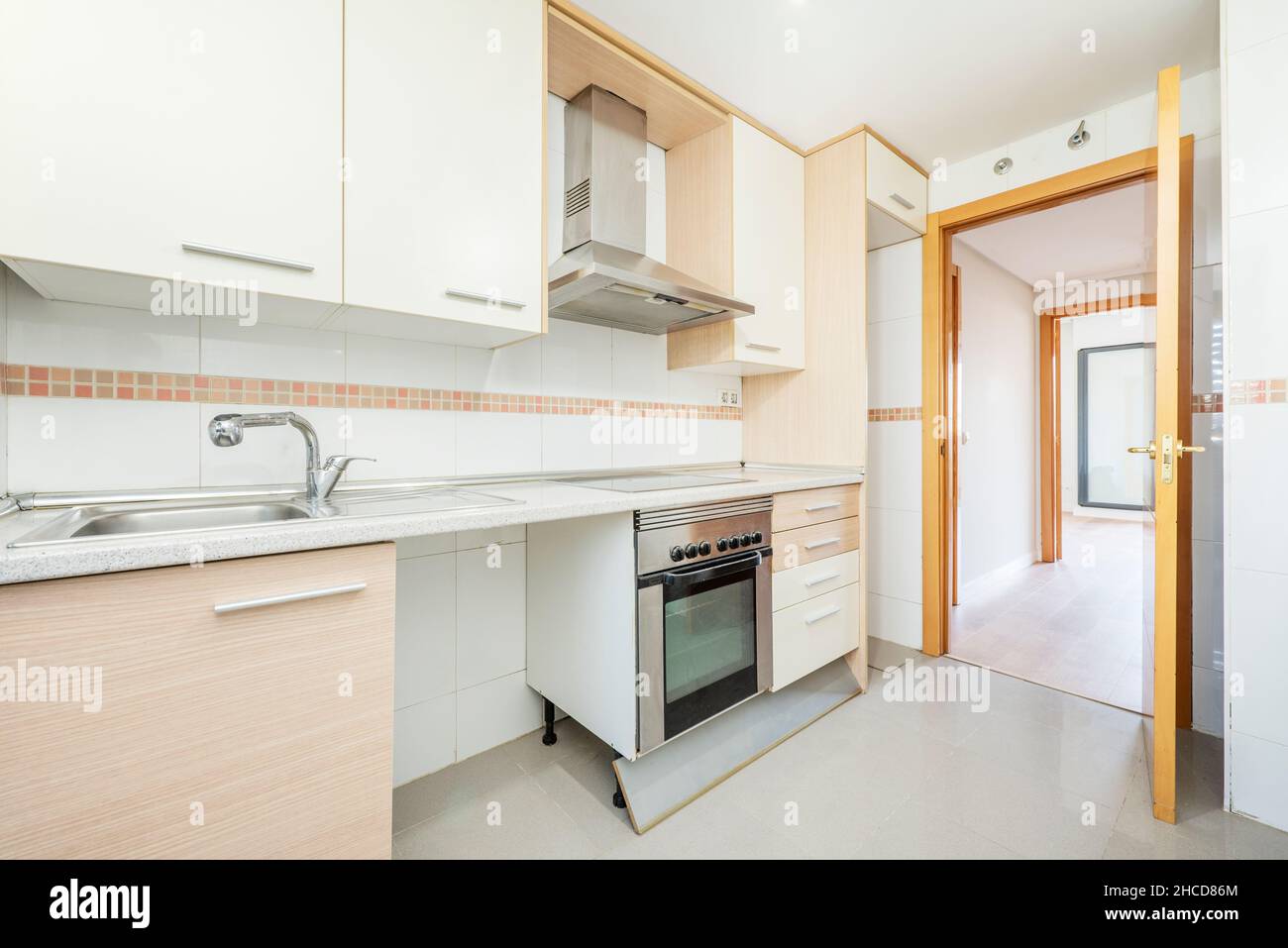 Kitchen with white and cream colored cabinets combined with stainless