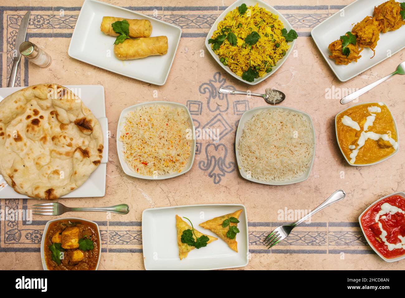Set of Indian food dishes with various flavors curry, garlic naan, and