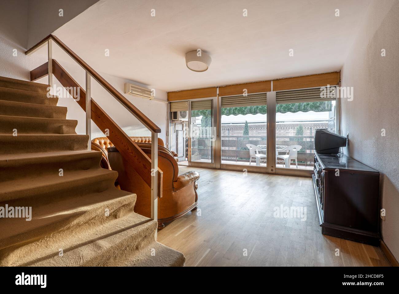 Loft stairs in living room with large window Stock Photo