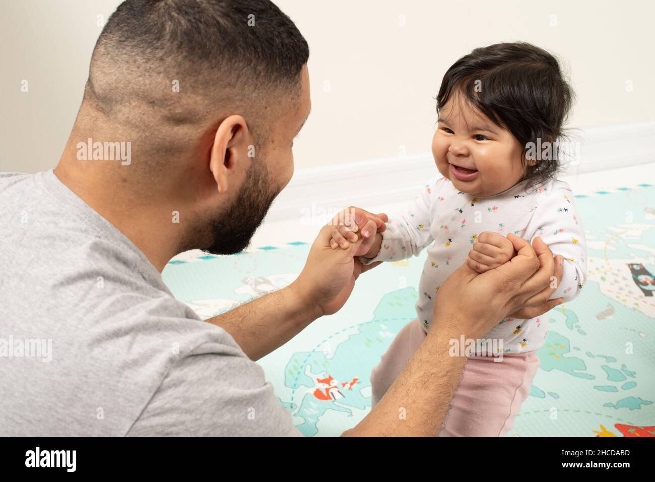 8 month old baby girl, interaction with father Stock Photo