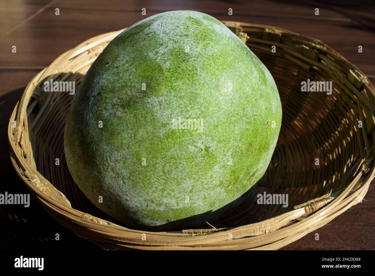 Fresh Indian vegetable called Ash gourd in wicker basket. Indian vegetable in wicker basket Stock Photo
