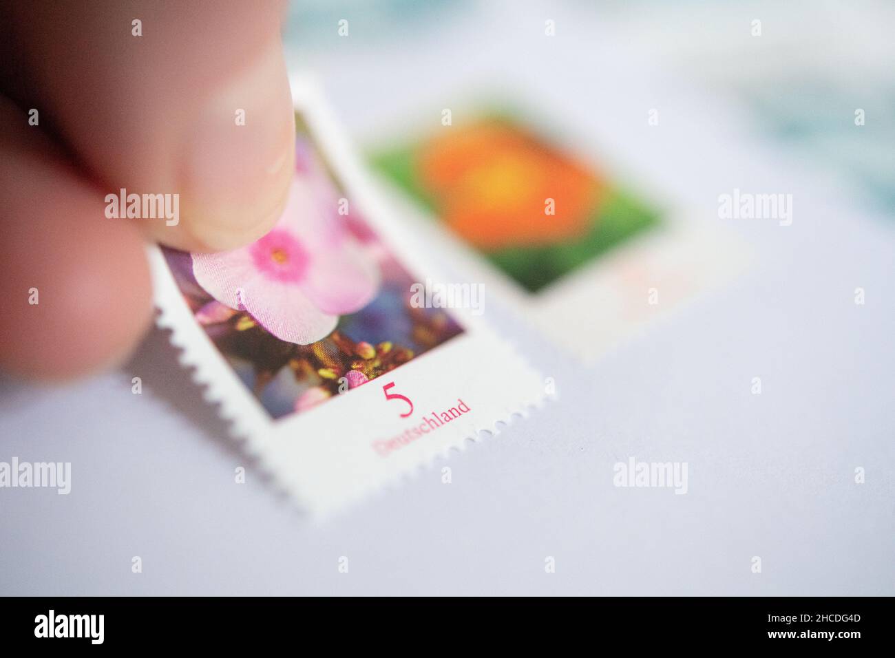Stuttgart, Germany. 27th Dec, 2021. ILLUSTRATION - A 5-cent stamp is affixed to a letter next to an 80-cent stamp. As of 1 January, the postage of domestic letters will increase, the standard letter will cost 85 cents in the future. Old stamps will remain valid, but letters will have to be franked additionally. Credit: Marijan Murat/dpa/Alamy Live News Stock Photo