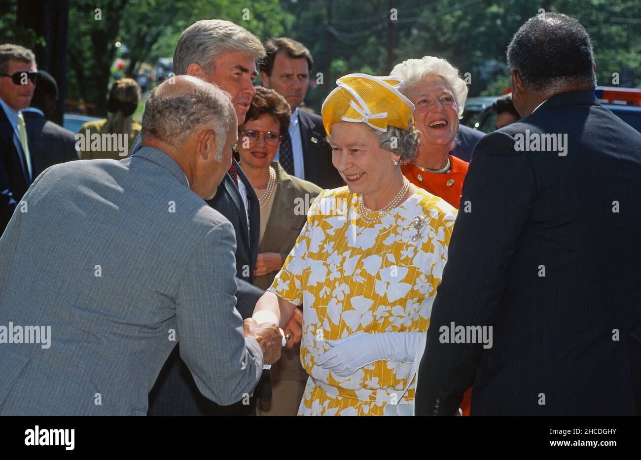 Queen Elizabeth II of Great Britain is greeted as she arrives to visit Drake Place, Southeast in Washington, DC on May 15, 1991.  Accompanying the Queen are United States Secretary of Housing and Urban Development Jack Kemp, Mayor Sharon Pratt Dixon (Democrat of the District of Columbia) and first lady Barbara Bush.  Drake Place is a group of new, affordable homes jointly funded by government and private interests.  The Queen is on a 12-day official visit to the US.Credit: Ron Sachs / Pool via CNP /MediaPunch Stock Photo