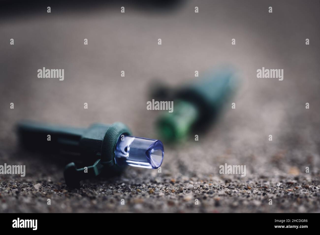 Focus on replacement bulb for a string of Christmas lights to repair a