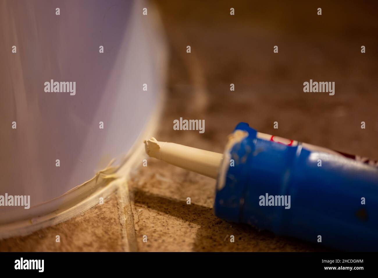 Selective focus on silicone caulking ready to be applied around the