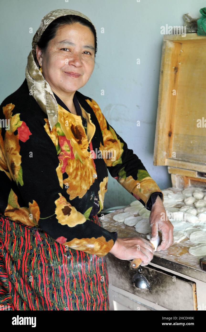 A Uyger woman prepares fresh dumplings for breakfast in Xinjiang China. Stock Photo